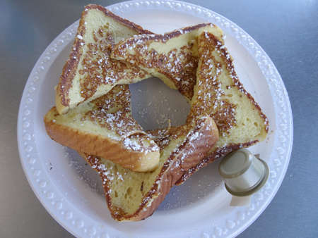 Sweet Bread French Toast - 5 Pieces with frosting and side of butter on a plastic plate.の写真素材