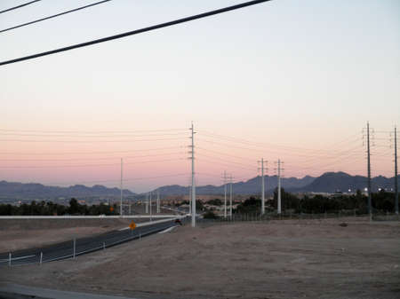 High Voltage Power-lines and Highway on-ramp at dusk in Las Vegas, Nevada.の写真素材