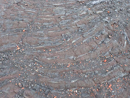 Ripples of Lava rock with small rocks on top on Big Island, Hawaii.の写真素材