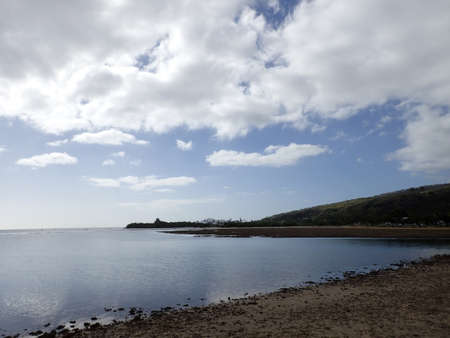 Rocky Shoreline beach along Maunalua Bay is a bay on the Southeast shore of the island of Oahu, between Diamond Head and Koko Head, and forming the shoreline of the Hawaii Kai area of Honolulu. "Maunalua" in Hawaiian means two mountains.の写真素材