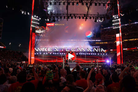 SANTA CLARA - MARCH 29: Fans cheer and record action on phones at close of Wrestlemania 31 as Seth Rollins celebrates championship victory by holding title in the air at the Levi's Stadium in Santa Clara, California on March 29, 2015.のeditorial素材