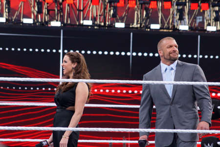 SANTA CLARA - MARCH 29: Triple H and Stephanie McMahon smile in the middle of the ring as they celebrate at Wrestlemania 31 at the Levi's Stadium in Santa Clara, California on March 29, 2015.のeditorial素材