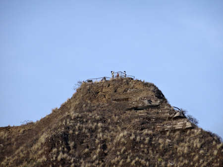 People take photos at Diamond Head Crater Lookout Peak with blue sky on Oahu, Hawaii.の写真素材