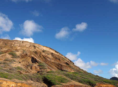 Close-up of top of Koko Head Mountain with blue sky with clouds visible on Oahu, Hawaii.の写真素材