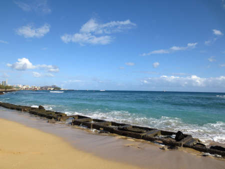 Old military water break on Sand Island Beach with Downtown Honolulu in the distance on Oahu, Hawaiiの写真素材