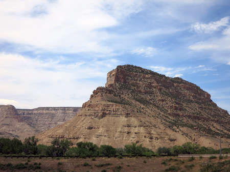 Colorado Rock Plateu revealing many layers and dramatic sky along road.の写真素材
