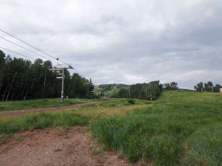 Gondola line goes up mountain as it sits empty in the summer at Snowmass, Colorado.の写真素材