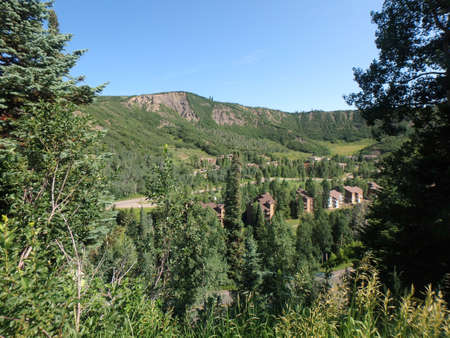 Snowmass Village area mountains, with condos, road, and trees in Colorado.の写真素材
