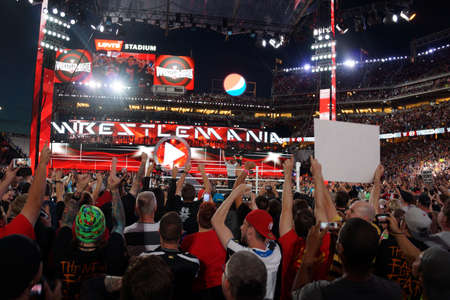 SANTA CLARA - MARCH 29:  Ref raises Seth Rollins arms as he celebrates with fans victory of the WWE Championship belt after winning main event match at Wrestlemania 31 at the Levi's Stadium in Santa Clara, California on March 29, 2015.のeditorial素材