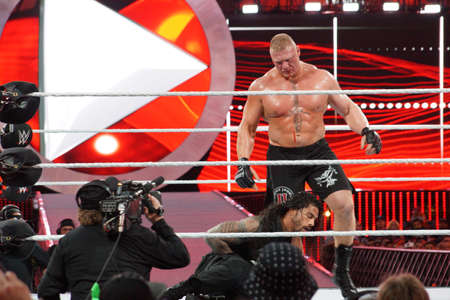 SANTA CLARA - MARCH 29: WWE Champion Brock Lesner bleeds from face as Roman Reigns holds stomach during main event match at Wrestlemania 31 at the Levi's Stadium in Santa Clara, California on March 29, 2015.のeditorial素材