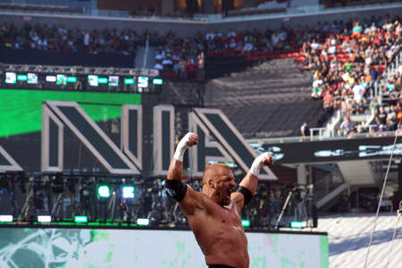SANTA CLARA - MARCH 29: Triple H lifts arms in the air as he stands on top of turnbuckles looking out into crowd before match at Wrestlemania 31 at the Levi's Stadium in Santa Clara, California on March 29, 2015.のeditorial素材