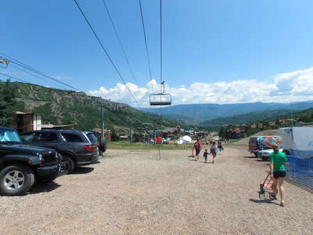 SNOWMASS, CO - JULY 4:  People walk along path during Wanderlust festival at Snowmass Village area mountains, with condos, road, and trees in Colorado on July 4, 2015.のeditorial素材