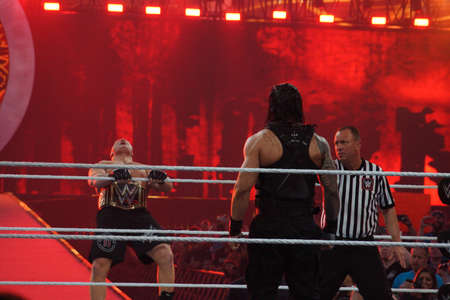 SANTA CLARA - MARCH 29: WWE Champion Brock Lesner screams as he leans back as he holds rope as he enters ring with Roman Reigns standing in ring at, showcase of the immortals, Wrestlemania 31,with fans cheering and taking photo at the Levi's Stadium in Saのeditorial素材