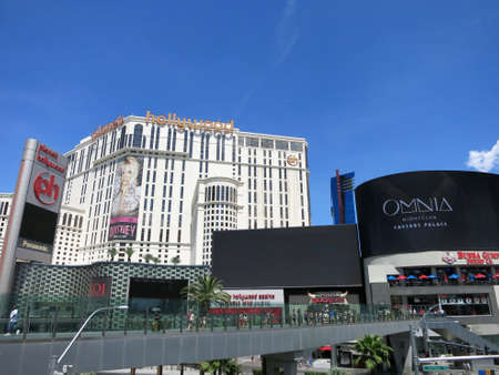 LAS VEGAS - JUNE 29: Pedestrian bridge to Planet Hollywood Hotel Miracle Mile with Britney Spears, Onmia ad and cloudy sky on June 29, 2015 in Las Vegas. VIP rooms at Planet Hollywood have movie themes and feature props from each movie.のeditorial素材