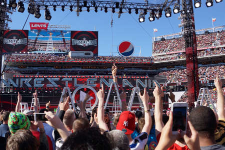 SANTA CLARA - MARCH 29: Daniel Bryan celebrates with yes chant with fans on top of ladder holding Intercontinental championship belt aafter winning ladder match at Wrestlemania 31 at the Levi's Stadium in Santa Clara, California on March 29, 2015.のeditorial素材