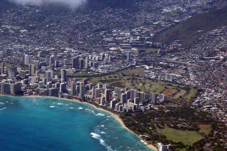 Aerial view of Diamondhead, Kapiolani Park, Waikiki, Shell, Ala Wai Canal, Kapahulu town, Highway, Pacific ocean, clouds, and Ala Wai Golf Course on Oahu, Hawaii.  June 2015.の写真素材