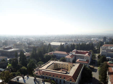 Birds eye view of Historic and modern Buildings of UC Berkeley Campus surrounded by trees with roads and paths intertwined with the landscape of the City of Berkeley in California looking towards San Francisco Bay on a very foggy day.  2011.のeditorial素材