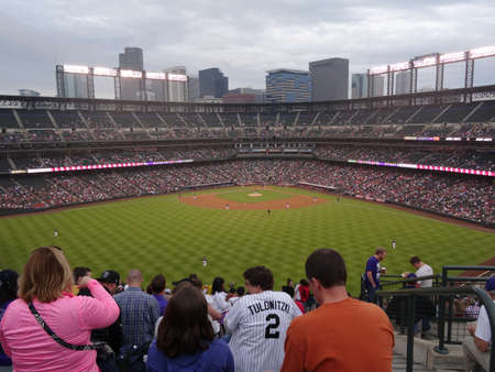 DENVER - JULY 7: Fans watch Angels vs. Rockies baseball game from the Outfield Bleachers with field and ballpark in view on July 7, 2015 in Denver, Colorado.のeditorial素材