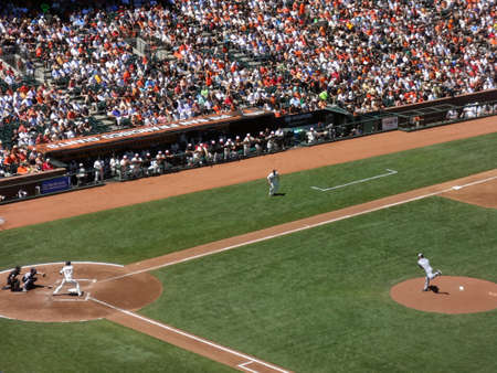 SAN FRANCISCO - JULY 3: Padres pitcher Clayton Richard steps forward as he throws pitch to Giants batter Aubrey Huff with ball in air during day game at ATT Park in San Franciso, CA on July 3, 2011.のeditorial素材