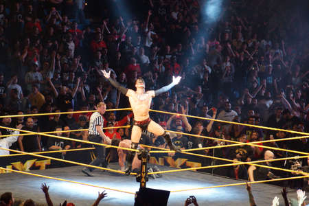 SAN JOSE - MARCH 27: NXT male wrestler Finn Balor opens arms as he stands on ropes while crowd cheers after match at the San Jose Event Center in San Jose, California on March 27, 2015.のeditorial素材