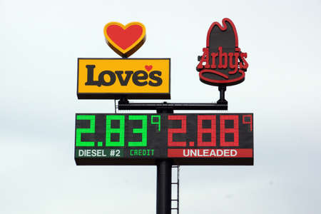 UTAH - JUNE 30: Loves Gas Station travel center and Arby's signs featuring the price of gas. Love's Travel Stops & Country Stores is a family-owned chain of more than 350 travel stops and convenience stores located in 40 states.  June 30, 2015 Utah.のeditorial素材