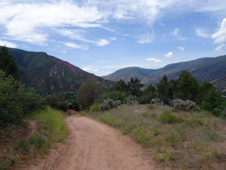 Dirt path in the forest leading down the mountains  in Greenwood Springs in Colorado, USA.  July 1, 2015.の写真素材