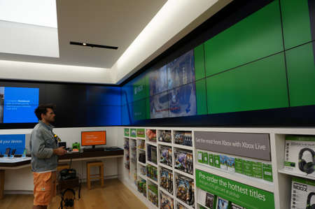 SAN FRANCISCO - OCTOBER 11:  Man stands holding controller plays  Xbox One inside Microsoft Windows...