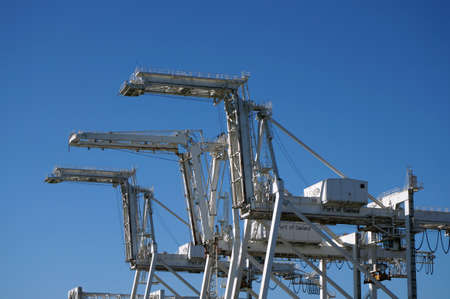 OAKLAND - OCTOBER 12: Close up of Row of large shipping crane featuring stairs leading up to higher sections with Port of Oakland written on side.  Oakland California on October 12, 2015.のeditorial素材