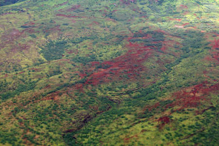 Aerial of Lush Green vegetation on Red Hills with dirt roads on Oahu, Hawaii.の写真素材