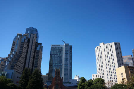 Blue Angels fly in formation in the sky with skyscrapers of downtown over in San Francisco California.のeditorial素材