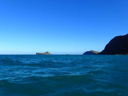 Gentle wave in Waimanalo Bay looking towards Rabbit island and Rock island at dusk on nice day Oahu, Hawaii. December 2015..の写真素材