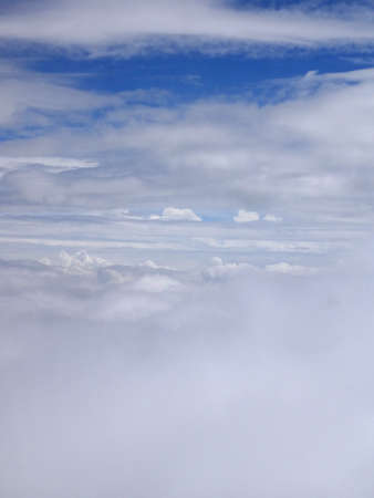 White Fluffy Clouds and blue sky high in the air.の写真素材