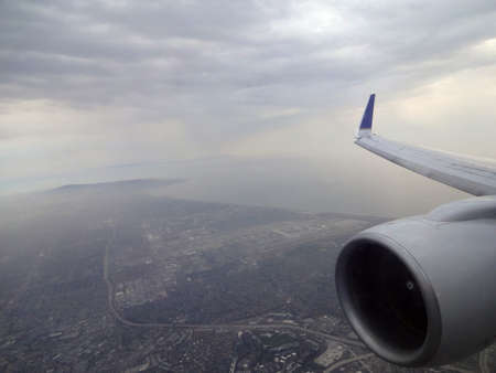 LA - JULY 15: Aerial high in the sky shot with the jet and wing of a commercial jet plane that turns...