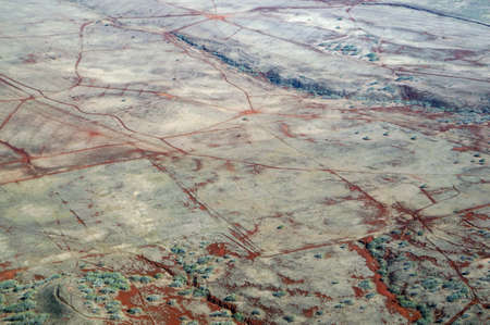 Aerial of Northwest counrtyside of Molokai with dirt roads, largely undeveloped with trees and...
