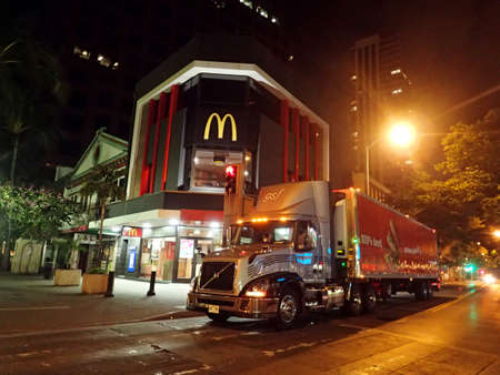 HONOLULU - JANUARY 8: Truck Delivers food to McDonalds Store in Downtown Honolulu, Hawaii at Night McDonald's primarily sells hamburgers, cheeseburgers, chicken, french fries, breakfast items, soft drinks, milkshakes, desserts.  on January 8, 2016, Honoluのeditorial素材