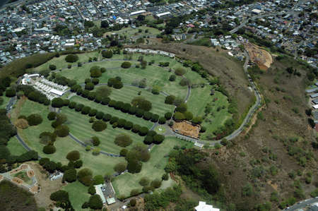 Aerial view of Punchbowl Cemetery or the National Memorial Cemetery of the Pacific, with parts under construction, which is visited by millions of tourist and island locals every year on the tropical island of Oahu in Honolulu, Hawaii, USA.のeditorial素材