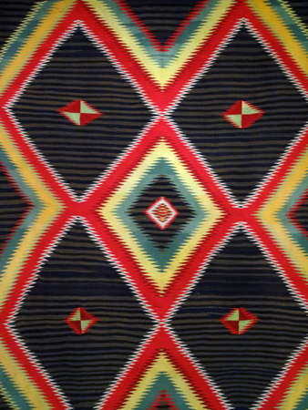 Pattern Red, Orange, White, Green, Black, yellow and blue Diamond Blanket/ Rug - Navajo Artist, made about 1885 of cotton and wool.                              の写真素材