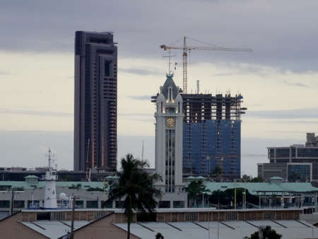 Historic Aloha Tower, which greeting arriving visitors for a century to Honolulu, and skyscraper...