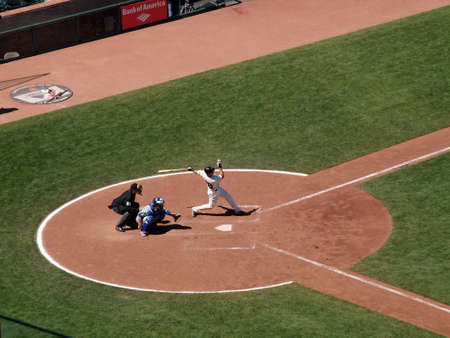 Giants Vs. Cubs: Giants Buster Posey swings and connects with ball in batters box waiting for pitch with Cubs catcher squatting behind him.  August 12  2010 Att Park San Francisco Californiaのeditorial素材
