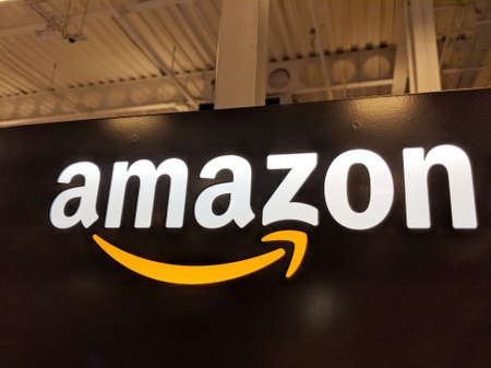 Honolulu - May 29, 2018:  Amazon logo on black shiny wall in Honolulu Best Buy store on January 12, 2017.  Amazon is an American international electronic commerce company. It is the world's largest online retailer.のeditorial素材
