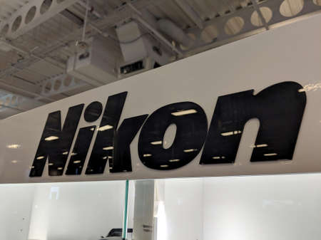 Honolulu - September 7, 2018:  Black Nikon logo on White shiny wall in Honolulu Best Buy store. Nikon Corporation, also known just as Nikon, is a Japanese multinational corporation headquartered in Tokyo, Japan, specializing in optics and imaging productsのeditorial素材