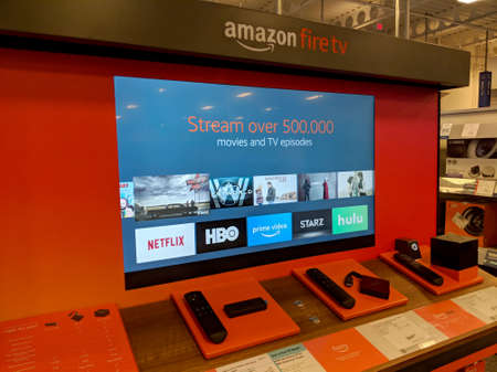Honolulu - September 7, 2018: Amazon Fire TV Display inside Best Buy Store.  Amazon Fire TV is a digital media player and its microconsole remote developed by Amazon. The device is a small network appliance that can deliver digital audio/video content strのeditorial素材