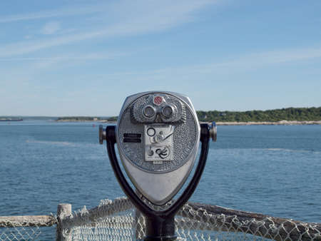 Portland, Maine -  May 28, 2010:  Coin operated binoculars look into the bay at Portland Head Lighthouse in Portland, Maine.のeditorial素材