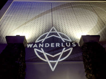 North Shore, Hawaii - February 28, 2019: Wanderlust O'ahu festival sign projected on the building at...