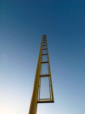 Yellow Baseball Foul Pole against blue sky.の写真素材