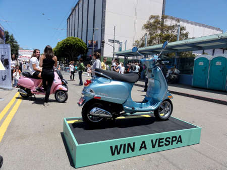 San Francisco  - July 2, 2011: Win A Vespa Motor Scooter Display as Street Fair in California.  Vespa (Italian pronunciation: ) is an Italian brand of scooter manufactured by Piaggio. The name means wasp in Italian. The Vespa has evolved from a single modのeditorial素材