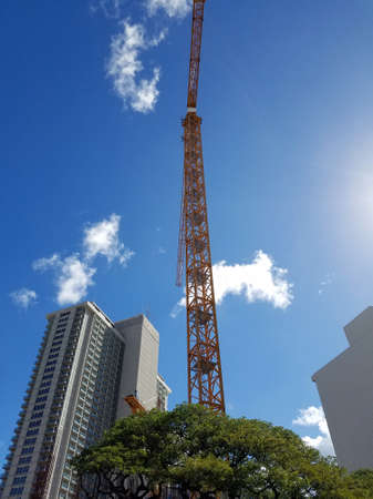 Honolulu - July 18, 2017: Construction Crane builds Kapiolani Residence, developed by South Korean SamKoo Pacific, is a 45 story glass and concrete high rise that will consist of studio, 1, 2 and 3 bedroom units. condo under construction, and surrounding のeditorial素材