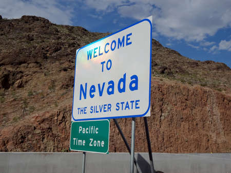 Nevada - July 28, 2011: Welcome to Nevada, The Silver State, Pacific Time Zone Sign along Freeway.のeditorial素材