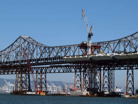 San Francisco - August 2, 2010: Half finished new Bay Bridge tower under construction, with old bridge behind it, connecting San Francisco and Oakland in California.のeditorial素材