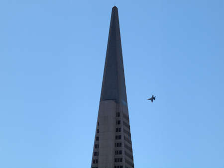 San Francisco - October 9, 2010: Top of Transamerica Pyramid with fighter jet flying by in San...